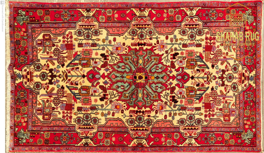 A hand-knotted Persian carpet from Nahavand,Iran, with geometric patterns in deep red and blue