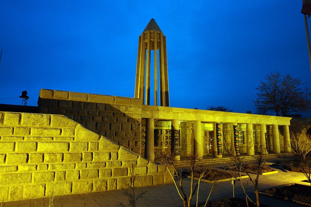 Close-up of a traditional hand-knotted Persian Hamadan rug with geometric medallion design in deep red and blue